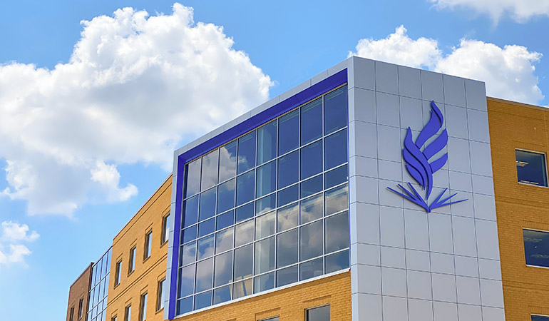 The exterior of NEOMED's main building, with the NEOMED logo shown prominently.