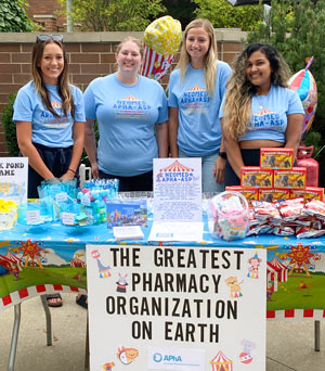 Pharmacy students promote their student organization at a NEOMED picnic.