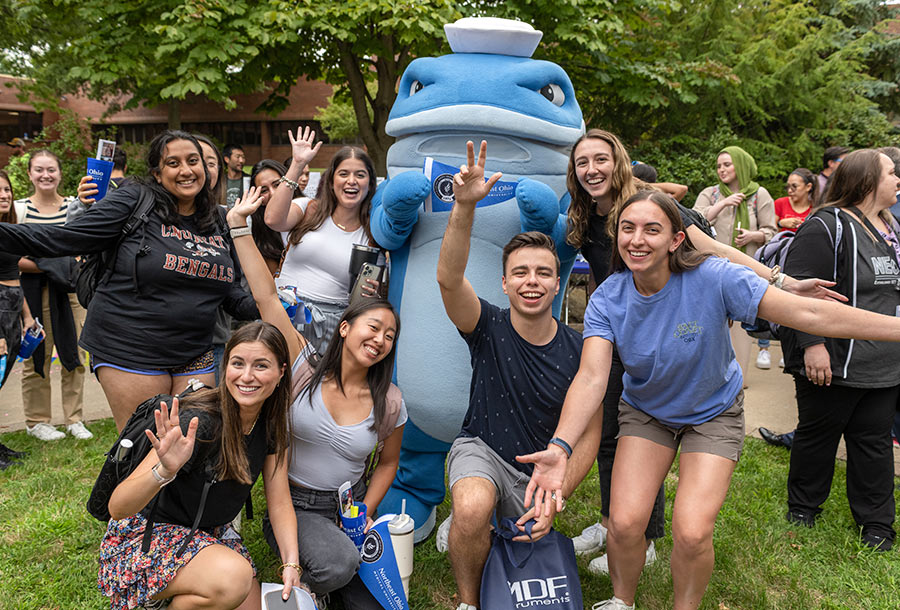 strategic-plan-2025-09 Students pose with the campus mascot, a costumed whale.